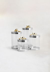 glass canisters with silver-toned steel bases and floral lids