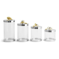 glass canisters with silver-toned steel bases and floral lids