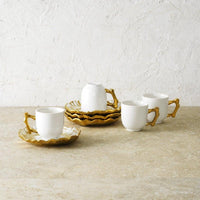 set of four plates and four espresso cups made of porcelain