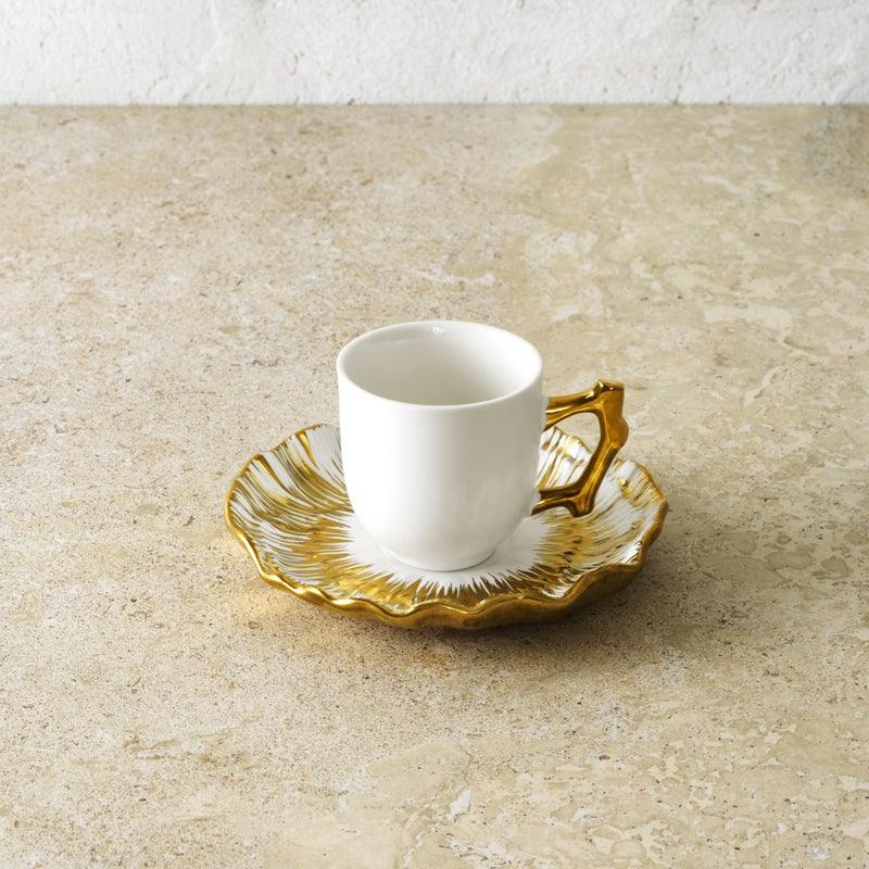 set of four plates and four espresso cups made of porcelain